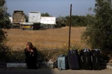 A woman waits for a travel permit to cross into Egypt through the Rafah border crossing after it was opened by Egyptian authorities on Wednesday for five days, in the southern Gaza Strip, June 30, 2016. PHOTO BY REUTERS/Ibraheem Abu Mustafa