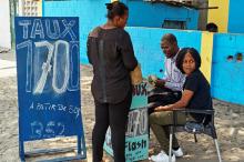 A woman exchanges dollars for Congolese francs at a street side exchange stall in Avenue du 24 Novembre, in Lingwala Municipality, Kinshasa, Democratic Republic of Congo, July 26, 2017. PHOTO BY REUTERS/Robert Carrubba