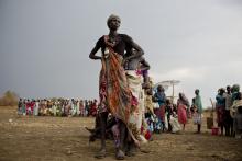 Women and children, displaced by recent fighting between rebel soldiers and government troops, wait in line to collect their food rations in Mingkaman refugee camp