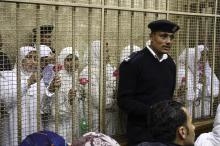 Women, who were found guilty of obstructing traffic during a pro-Islamist protest in October, smile during their appeal hearing at a court in the Mediterranean city of Alexandria, 230 km (143 miles) north of Cairo