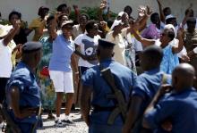 Women sing and dance in front of police during a protest by women against president Pierre Nkurunziza in Bujumbura, Burundi, May 10. 2015. PHOTO BY REUTERS/Goran Tomasevic