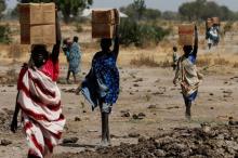 Women carry boxes of nutritional food delivered by the United Nations World Food Programme (UN WFP), in Rubkuai village, Unity State, South Sudan, February 16, 2017. PHOTO BY REUTERS/Siegfried Modola