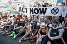 French youth and environmental activists block a bridge during a demonstration to urge world leaders to act against climate change, in Paris, France, June 28, 2019. PHOTO BY REUTERS/Charles Platiau