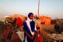 Zeinab, 14, poses for a photograph beside her shelter at a camp for internally displaced people from drought hit areas in Dollow, Somalia, April 2, 2017. PHOTO BY REUTERS/Zohra Bensemra