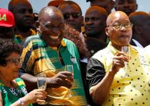 African National Congress (ANC) President Cyril Ramaphosa (L) reatcs as he celebrates the Congress' 106th anniversary celebrations with former President of South Africa Jacob Zuma, in East London, South Africa, January 13, 2018. PHOTO BY REUTERS/Siphiwe Sibeko