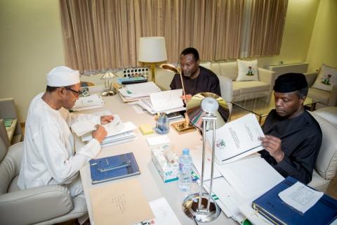 President Muhammadu Buhari, Vice President Yemi Osinbajo and Minister of Budget and National Planning Senator Udoma Udo Udoma read copies of the details of the submitted 2016 national budget by the National Assembly in Abuja, Nigeria April 10, 2016. PHOTO BY REUTERS/Stringer