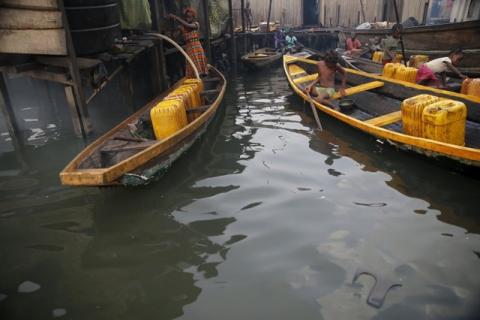 People fetch water in containers in canoes at a water selling point in the Makoko fishing community on the Lagos Lagoon, Nigeria, February 29, 2016. PHOTO BY REUTERS/Akintunde Akinleye
