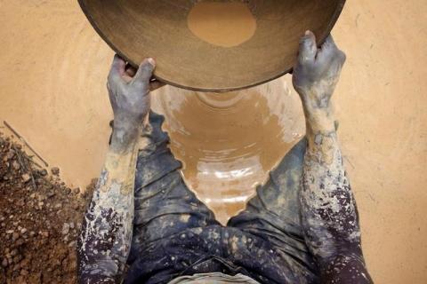 Artisanal gold miner Mamadou Diarra pans for gold at a small scale mine in Kalana, August 26, 2012. PHOTO BY REUTERS/Joe Penney