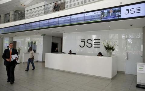 People walk near the reception at the Johannesburg Stock Exchange (JSE) in Sandton, Johannesburg, South Africa, December 10, 2015. PHOTO BY REUTERS/Siphiwe Sibeko