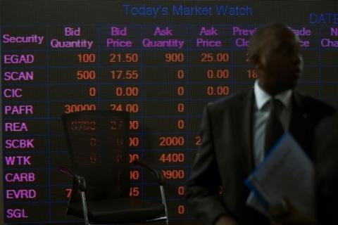 A man stands in front of an electronic board displaying market data at the Nairobi Securities Exchange in Nairobi, Kenya, April 11, 2017. PHOTO BY REUTERS/Baz Ratner