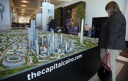 A delegate looks at a model of a planned new capital for Egypt during the final day of Egypt Economic Development Conference (EEDC) in Sharm el-Sheikh, in the South Sinai governorate, south of Cairo, March 15, 2015. PHOTO BY REUTERS/Amr Abdallah Dalsh