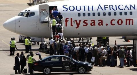 Passengers board a South African Airways Boeing 737 aircraft at the Kamuzu International Airport in Lilongwe. PHOTO BY REUTERS/Siphiwe Sibeko