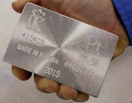 An employee holds a marked ingot of 99.98 percent pure platinum at the Krastsvetmet Krasnoyarsk non-ferrous metals plant in the Siberian city of Krasnoyarsk, Russia, June 5, 2015. PHOTO BY REUTERS/Ilya Naymushin