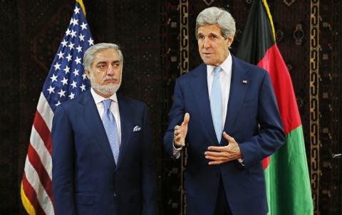 U.S. Secretary of State John Kerry speaks as he stands next to Afghanistan's presidential candidate Abdullah Abdullah (L) at the start of a meeting at the U.S. embassy in Kabul