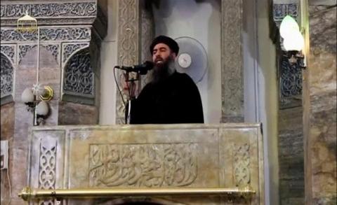 A man purported to be the reclusive leader of the militant Islamic State Abu Bakr al-Baghdadi making what would have been his first public appearance, at a mosque in the centre of Iraq's second city, Mosul, according to a video recording posted on the Internet on July 5, 2014. PHOTO BY  REUTERS/Social Media Website 