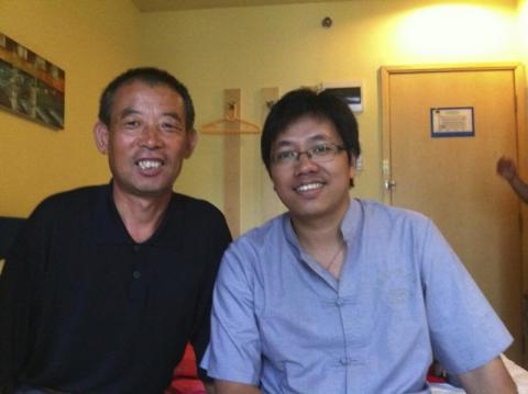 Chen Guangfu (L), elder brother of blind activist Chen Guangcheng and father of Chen Kegui, posing with Guo Yushan (R), a Beijing-based researcher and rights activist, during a meeting in Nanjing, Jiangsu province