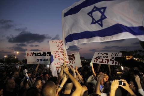 Far-right Israeli activists hold placards and shout slogans against the wedding of Mahmoud Mansour and Maral Malka (not pictured) in Rishon Lezion, near Tel Aviv, August 17, 2014. PHOTO BY REUTERS/Ammar Awad