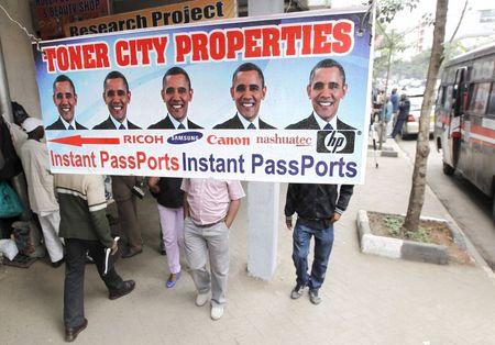Residents walk past a commercial poster with the portrait photo of the U.S. President Barack Obama ahead of his scheduled State visit in Kenya's capital Nairobi, July 23, 2015. PHOTO BY REUTERS/Thomas Mukoya