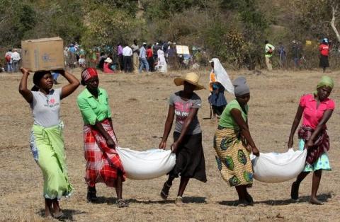 Villagers collect their monthly food aid provided by United Nations World Food Programme (WFP) in Bhayu, Zimbabwe, September 14, 2016. PHOTO BY REUTERS/Philimon Bulawayo