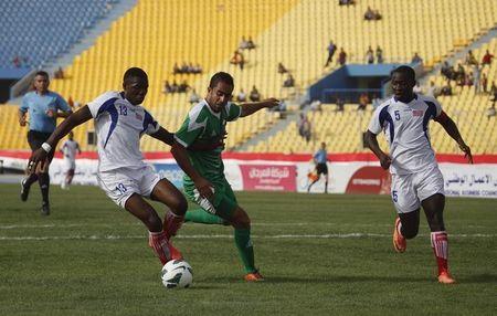 Alex Karmoh of Liberia (L) challenges Mustafa Karem of Iraq during their international friendly soccer match at al-Shaab Stadium in Baghdad, May 27, 2013. PHOTO BY REUTERS/Thaier al-Sudani
