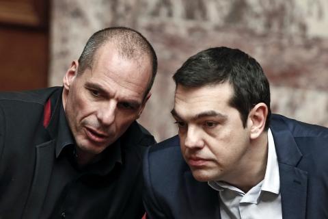 Greek Prime Minister Alexis Tsipras (R) and Finance Minister Yanis Varoufakis talk during the first round of a presidential vote at the Greek parliament in Athens, February 18, 2015. PHOTO BY REUTERS/Alkis Konstantinidis