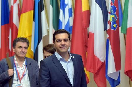 Greece's Prime Minister Alexis Tsipras (C) and Greek Finance Minister Euclid Tsakalotos (L) leave a euro zone leaders summit in Brussels, Belgium, July 13, 2015. PHOTO BY REUTERS/Eric Vidal