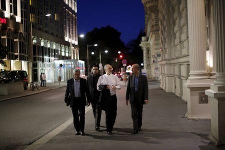 Head of the Iranian Atomic Energy Organization Ali Akbar Salehi (2nd R) walks near the hotel where the Iran nuclear talks meetings are being held in Vienna, Austria in Vienna, Austria July 4, 2015. PHOTO BY REUTERS/Carlos Barria