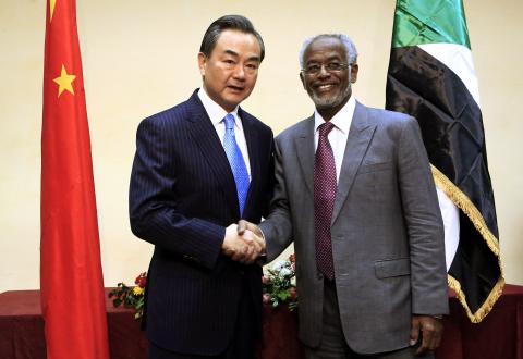 Sudan's Foreign Minister Ali Karti (R) shakes hands with China's Foreign Minister Wang Yi upon his arrival for a visit in Khartoum, January 11, 2015. PHOTO BY REUTERS/ Mohamed Nureldin Abdallah