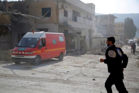A civil defence member runs near an ambulance after an airstrike on a hospital in the town of Meles, western Idlib city in rebel-held Idlib province, Syria, August 6, 2016. PHOTO BY REUTERS/Ammar Abdullah