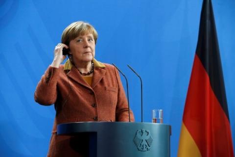 German Chancellor Angela Merkel adjusts her earpiece during a news conference with Portugal's Prime Minister Antonio Costa at the Chancellery in Berlin, Germany, February 5, 2016. PHOTO BY REUTERS/Fabrizio Bensch