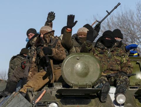 Members of the Ukrainian armed forces ride on a military vehicle near Debaltseve, eastern Ukraine, February 17, 2015. PHOTO BY REUTERS/Gleb Garanich