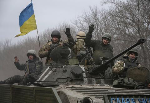 Members of the Ukrainian armed forces ride an armoured personnel carrier near Debaltseve, eastern Ukraine, February 20, 2015. PHOTO BY REUTERS/Gleb Garanich