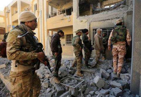 The Iraqi army inspects a building during a battle with Islamic State militants in Al-shuqaq neighbourhood north of Mosul, Iraq. PHOTO BY REUTERS/Ari Jalal