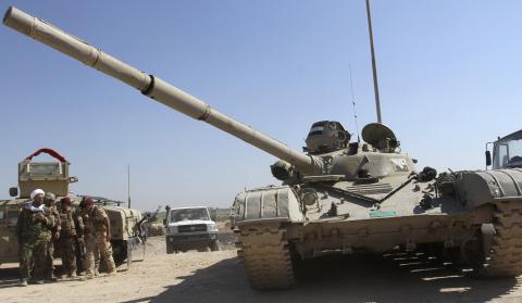 An armoured vehicle belonging to the Iraqi army patrols in Jurf al-Sakhar, October 25, 2014. PHOTO BY REUTERS/Stringer