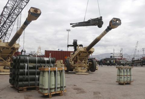 Workers unload artillery, part of a military donation from the U.S. government to the Lebanese army, during a ceremony at Beirut's port, February 8, 2015. PHOTO BY REUTERS/Mohamed Azakir