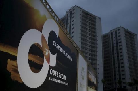A banner of Odebrecht SA is pictured in front of buildings under construction at the Rio 2016 Olympic Games athletes village in Rio de Janeiro, Brazil July 21, 2015. PHOTO BY REUTERS/Ricardo Moraes