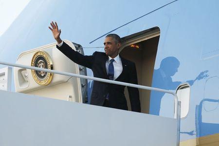 U.S. President Barack Obama waves as he boards Air Force One for travel to Kenya and Ethiopia from Joint Base Andrews, Maryland, July 23, 2015. PHOTO BY REUTERS/Jonathan Ernst