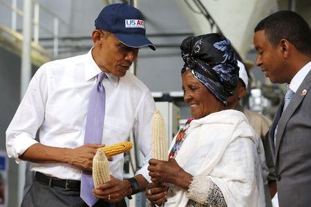 U.S. President Barack Obama (L) speaks with a farmer (2nd R) participating in the Feed the Future program as he tours the Faffa Food factory in Addis Ababa, Ethiopia, July 28, 2015. PHOTO BY REUTERS/Jonathan Ernst