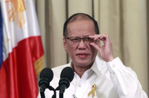 Philippines' President Benigno Aquino adjusts his eyeglasses while giving a nationwide televise statement on the Comprehensive Agreement on the proposed Bangsamoro Basic Law at the presidential palace in Manila, March 27, 2015. PHOTO BY REUTERS/Romeo Ranoco