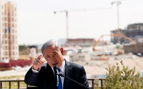 Israeli Prime Minister Benjamin Netanyahu delivers a statement in front of a new construction, in the Jewish settlement known to Israelis as Har Homa and to Palestinians as Jabal Abu Ghneim, in an area of the West Bank that Israel captured in a 1967 war and annexed to the city of Jerusalem, March 16, 2015. PHOTO BY REUTERS/Ronen Zvulun