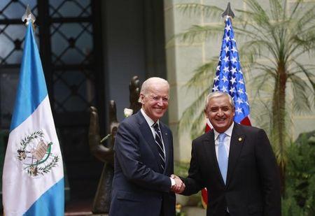 File photo of U.S. Vice-President Joe Biden (L) and Guatemala's then-president Otto Perez Molina shaking hands during a photo opportunity at the Presidential Palace in Guatemala City, March 2, 2015. PHOTO BY REUTERS/Jorge Dan Lopez
