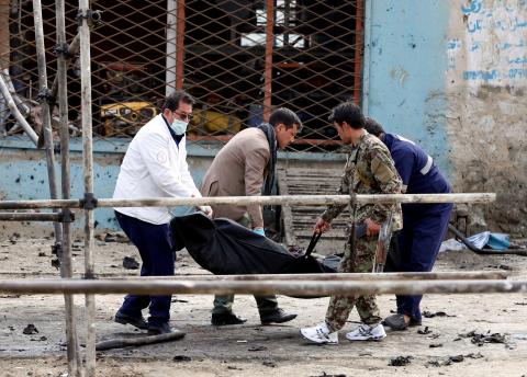 Afghan officials carry the dead body of a victim at the site of a suicide bomb attack near a Shi'ite mosque in Kabul, Afghanistan, March 9, 2018. PHOTO BY REUTERS/Omar Sobhani