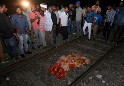 People surround the body of a victim lying on a railway track after an accident in Amritsar, India, October 19, 2018. PHOTO BY REUTERS/Munish Sharma