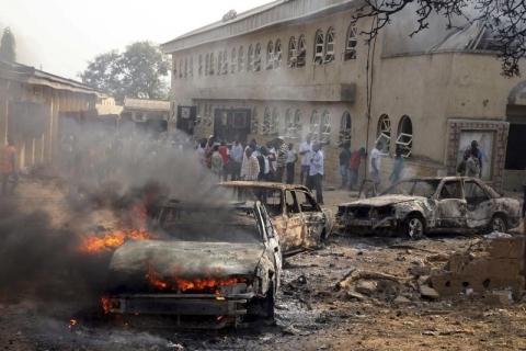 A car burns at the scene of a bomb explosion at St. Theresa Catholic Church at Madalla, Suleja, just outside Nigeria's capital Abuja, December 25, 2011. PHOTO BY REUTERS/Afolabi Sotunde