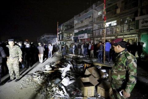 Iraqi security forces gather at the site of a car bomb in New Baghdad, January 11, 2016. PHOTO BY REUTERS/Ahmed Saad
