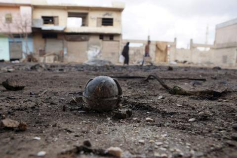 An unexploded cluster bomblet is seen along a street after airstrikes by pro-Syrian government forces in the rebel held al-Ghariyah al-Gharbiyah town, in Deraa province, Syria, February 11, 2016. PHOTO BY REUTERS/Alaa Al-Faqir