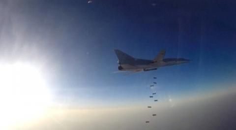 A still image, taken from video footage and released by Russia's Defence Ministry on August 16, 2016, shows a Russian Tupolev Tu-22M3 long-range bomber based in Iran dropping off bombs at an unknown location in Syria. PHOTO BY REUTERS/Ministry of Defence of the Russian Federation