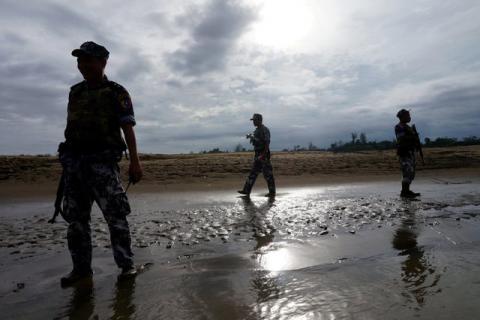 A Myanmar border guard police officers stand guard in Buthidaung, northern Rakhine state, Myanmar, July 13, 2017. PHOTO BY REUTERS/Simon Lewis