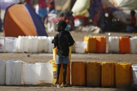 An internally displaced boy waits for water inside a United Nations Missions in Sudan (UNMIS) compound in Juba, December 19, 2013. PHOTO BY REUTERS/Goran Tomasevic