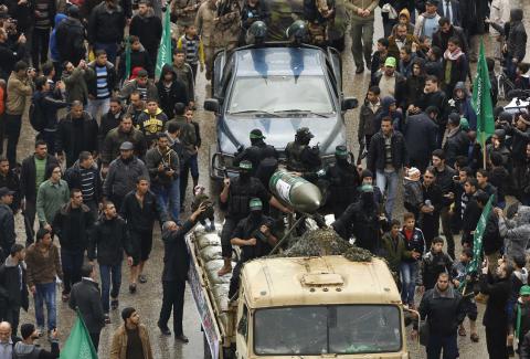 Palestinian members of al-Qassam Brigades, the armed wing of the Hamas movement, display home-made rockets during a military parade marking the 27th anniversary of Hamas' founding, in Gaza City, December 14, 2014. PHOTO BY REUTERS/Suhaib Salem